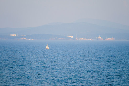 Fototapeta Small yacht in black sea panorama