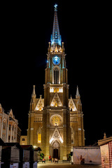 Naklejka premium Novi Sad, Serbia May 27, 2018 : Night view of the Liberty Square (Trg. Slobode) with Mary Church, tourists and old buildings.