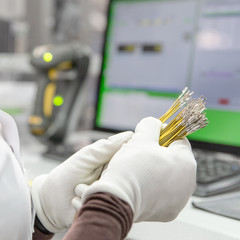 Employee checks the quality of the product, bunch of sliced wires with pins in hands of worker , manufacturing
