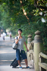 Obraz premium Asian male model poses for pictures on the street