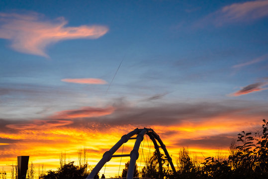 Warm sunset and silhouette of suspended bridge in the city of Valencia, Spain.