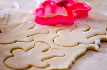 Abstract selective focus macro view of sugar cookie Christmas dough cut out with a gingerbread cookie cutter