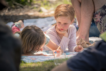 Fototapeta premium girl lokking at her friend drawing