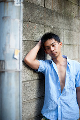 Obraz premium Asian male model poses for pictures on the street