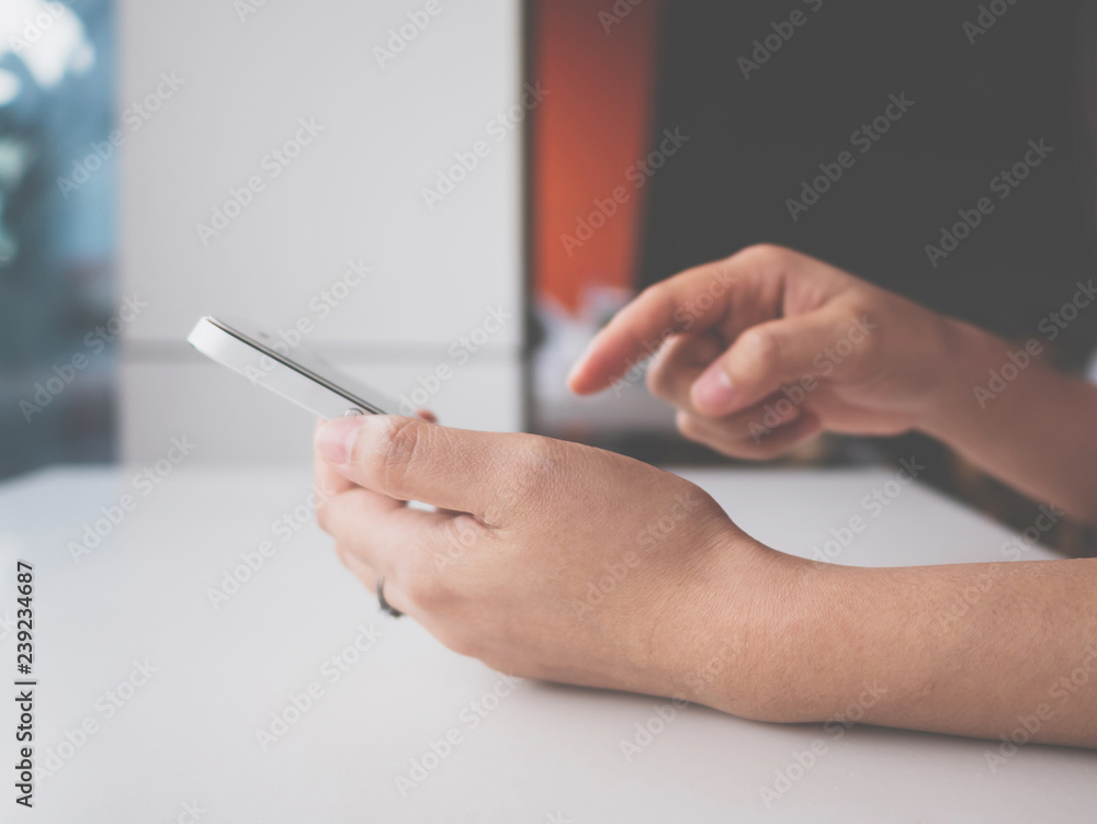 Poster woman hand holding and touching white mobile phone. she using application typing text message on sma