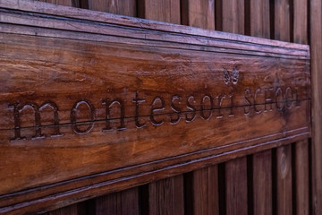 Wooden sign with the inscription montessori engraved on it.