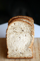 Slice white breads on the wooden board.