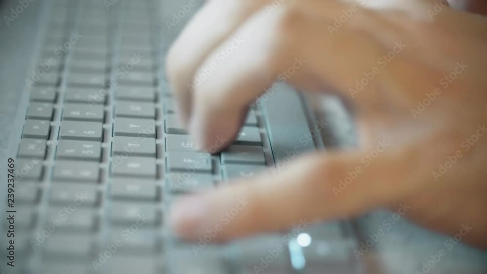 Poster hands typing on the modern computer keyboard, extreme close-up
