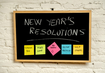 Fototapeta premium New Year resolutions or popular Goals and colorful sticky post its notes on chalk blackboard