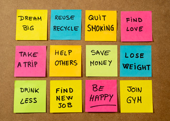 New Year resolutions or popular Goals and colorful sticky post its memo notes on cork board