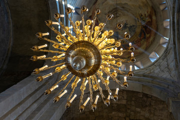 Big bronze chandelier in old orthodox cathedral, closeup
