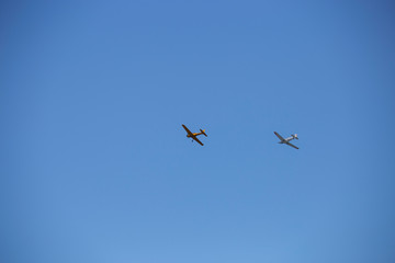 Small airplanes doing aerial acrobatics in a exhibition