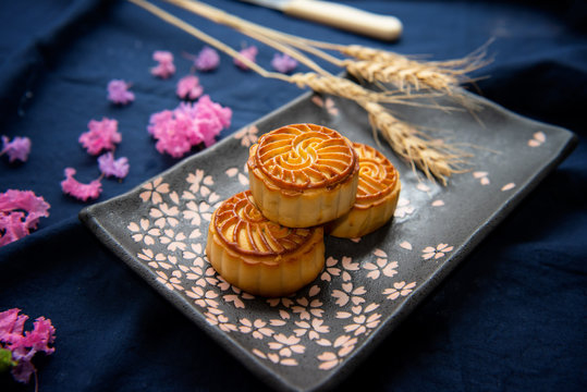 Chinese traditional food moon cakes and pink flowers