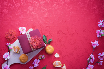 Gift box and Cherry blossom with Copy space for text on red texture background, concept of Chinese new year background.