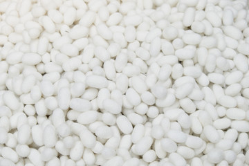 silkworm (Bombyx Mori) cocoons. This is a natural source of silk before it's processed.Natural white cocoon or silkworm nets for background, a source of silk thread and silk fabric
