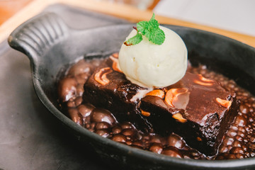 Brownie Sundae with a Scoop of Vanilla Ice Cream, Chocolate Sauce, Whipped Cream, and Nuts with Copy Space