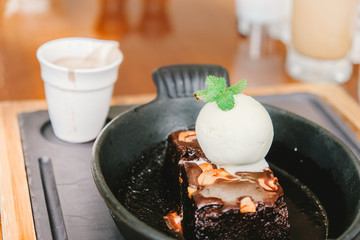 Brownie Sundae with a Scoop of Vanilla Ice Cream, Chocolate Sauce, Whipped Cream, and Nuts with Copy Space