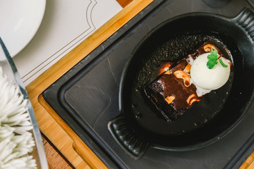 Brownie Sundae with a Scoop of Vanilla Ice Cream, Chocolate Sauce, Whipped Cream, and Nuts with Copy Space