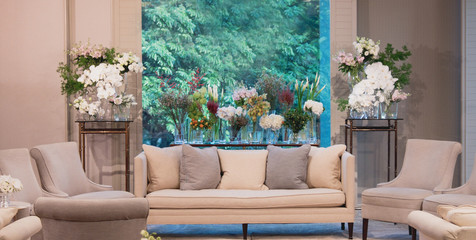 beautiful interior - white sofa and flowers in vases