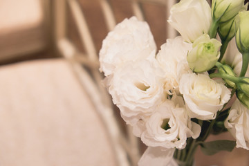 Bouquet of white flowers in a vase, candles. wedding home decor on a table