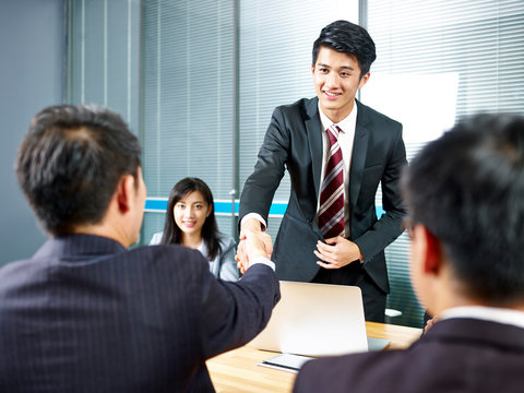 Asian Business Men Shaking Hands Before Meeting