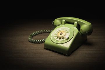 Old telephone on a wooden table