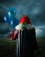 Selbstklebende Fototapeten Gruseliger Clown auf einem Feld in der Nacht © fergregory