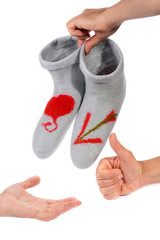 Woolen socks in male hands on a white background