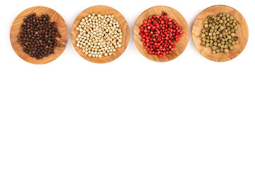 Mixed of peppers hot, red, black, white and green pepper in wooden bowl isolated on white background with copy space for your text. Top view