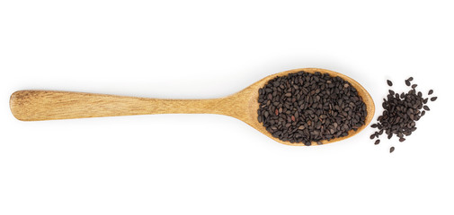 Black sesame seeds in a wooden spoon isolated on white background. Top view. Flat lay