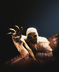 Scary halloween mummy on a dark background - obrazy, fototapety, plakaty