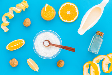 homemade spa with citrus cosmetic oil on blue background top view pattern