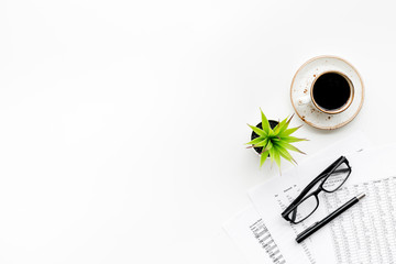 Breakfast in office with coffee on the work desk with documents and glasses on white background top view space for text
