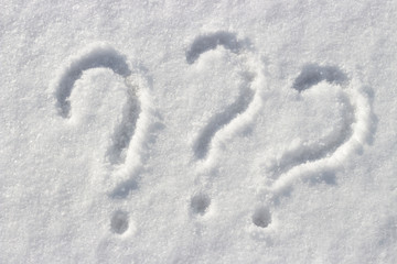 Question mark on white snow, close up, copy space