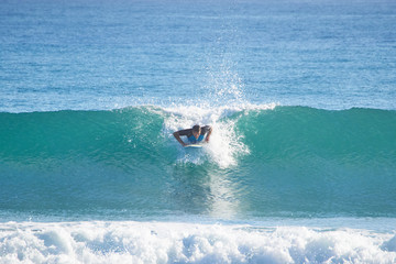 man surfer in the ocean catches the wave