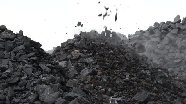 Slow motion shot of crushing stone. Falling rocks in quarry mine industry