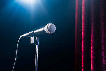 microphone on a stand up comedy stage with reflectors ray, high contrast image