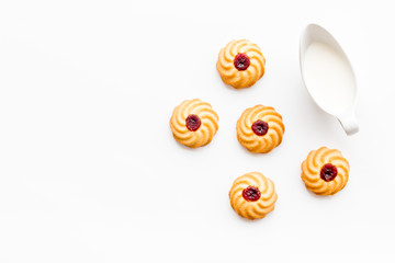 Drink milk with cookies concept. Cup of milk and fresh homemade cookies on white background top view copy space