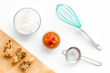 Cook cookies at home concept. Fresh cookies near whisk, flour, sieve on white background top view
