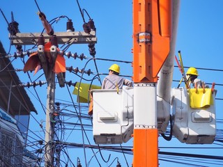 Electricians are repairing high-voltage electricity on high, to repair defective equipment, which...