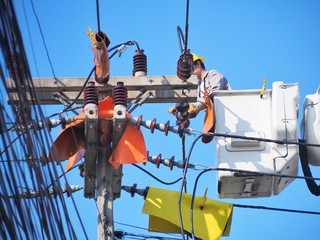 Electricians are repairing high-voltage electricity on high, to repair defective equipment, which...