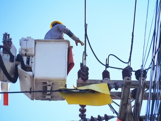Electricians are repairing high-voltage electricity on high, to repair defective equipment, which causes power outage.