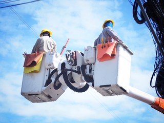 Electricians are repairing high-voltage electricity on high, to repair defective equipment, which...