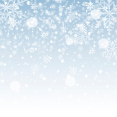 Blurred Christmas background with snowflakes and blue sky. Vector