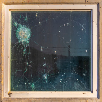 Bulletproof glass with gun shots and break