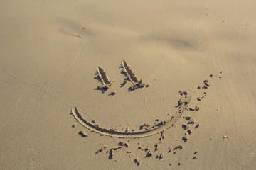 smile drawn in the sand