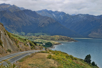 Adventurous lakeside drive by a lake in the New Zealand mountains 