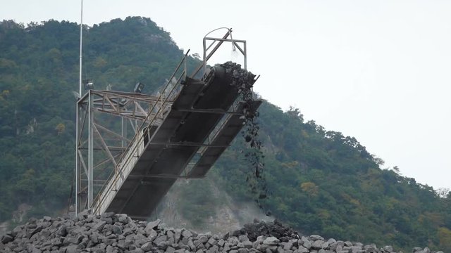 Slow motion shot of quarry mine industry rock extraction heavy machinery equipment