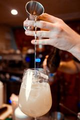 Bartender making alcoholic cocktails in bar! Spirits drinks on bar table