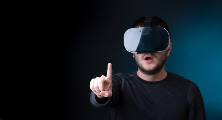 Photo of surprised brunet in virtual reality glasses